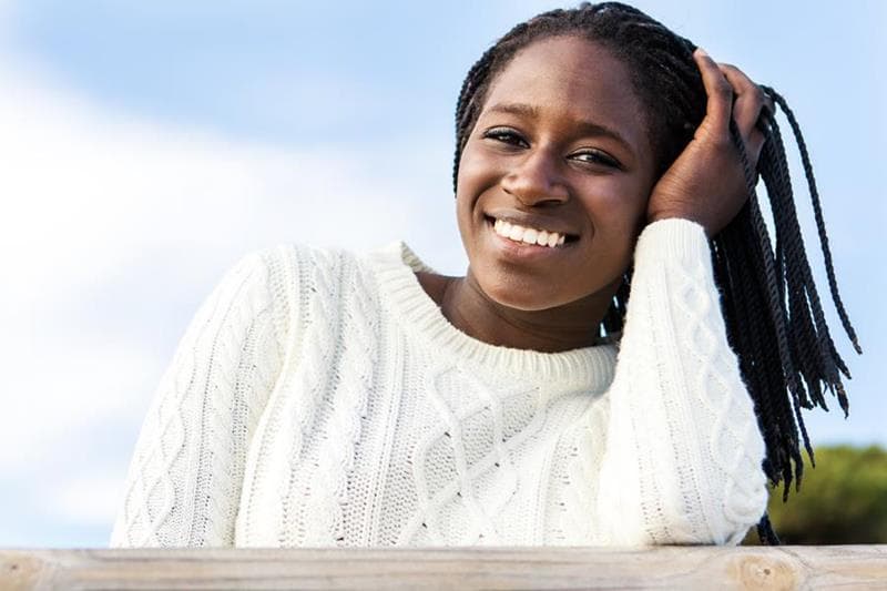 Smiling patient with braids