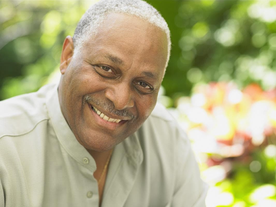 Older man smiling outdoors